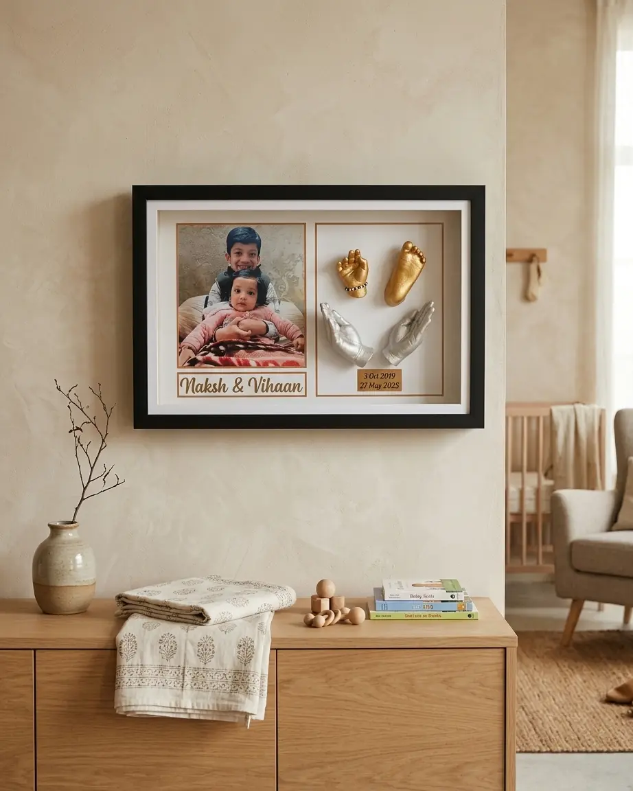 Black landscape frame with a sibling portrait, a baby's gold-cast hand and foot and an elder sibling's two silver-cast hands